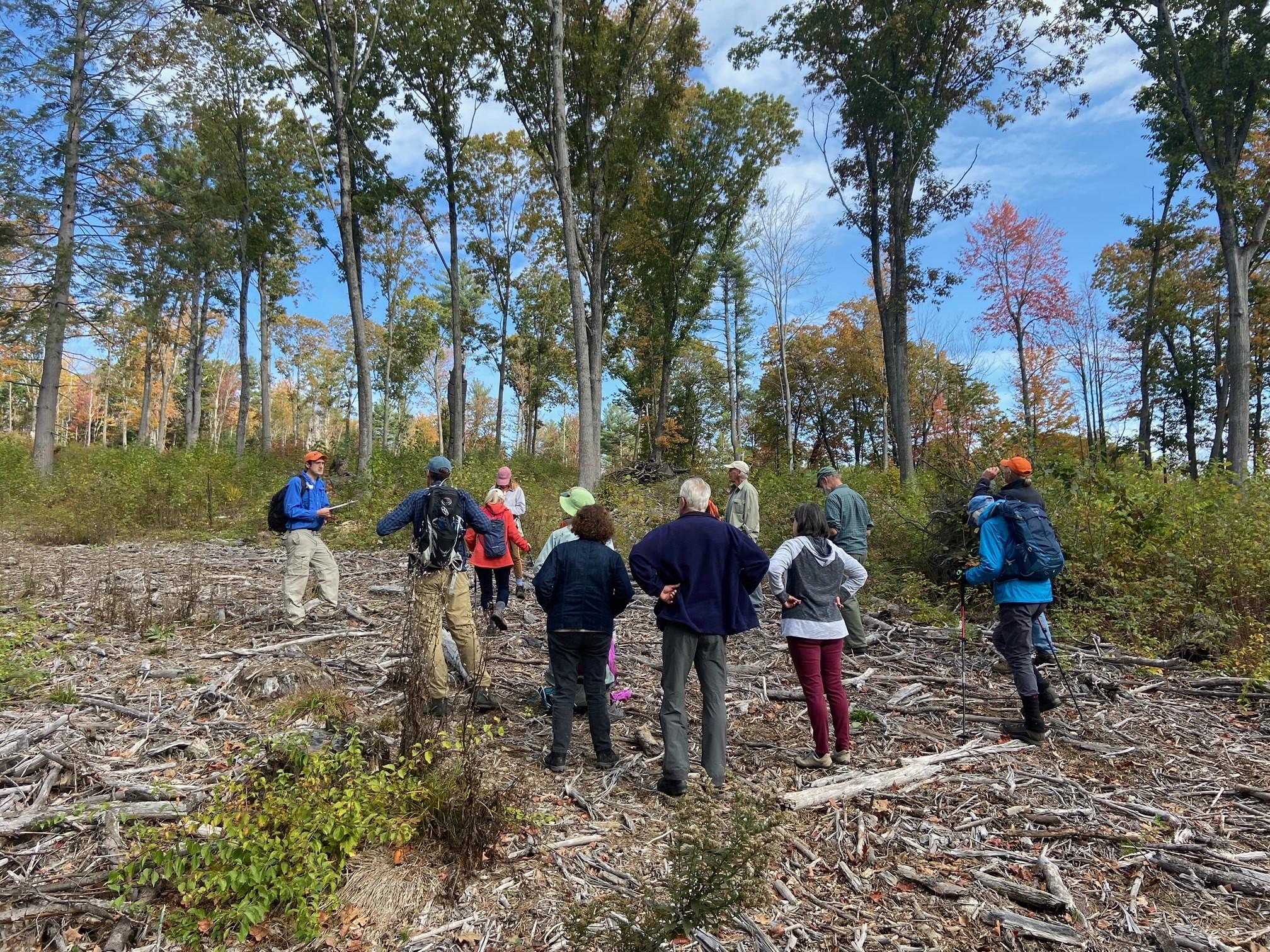 A group gathers to hear from field forester Gabe Roxby.