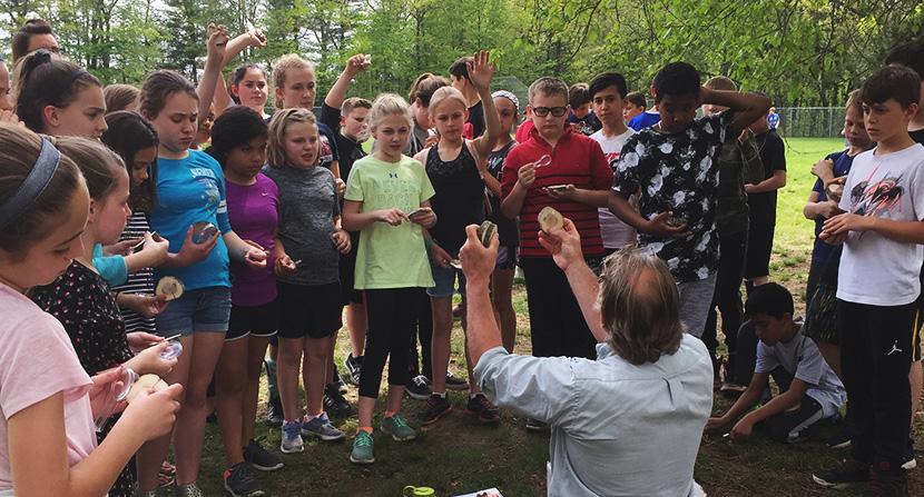 Students inspect tree cookies for a tree identification lesson