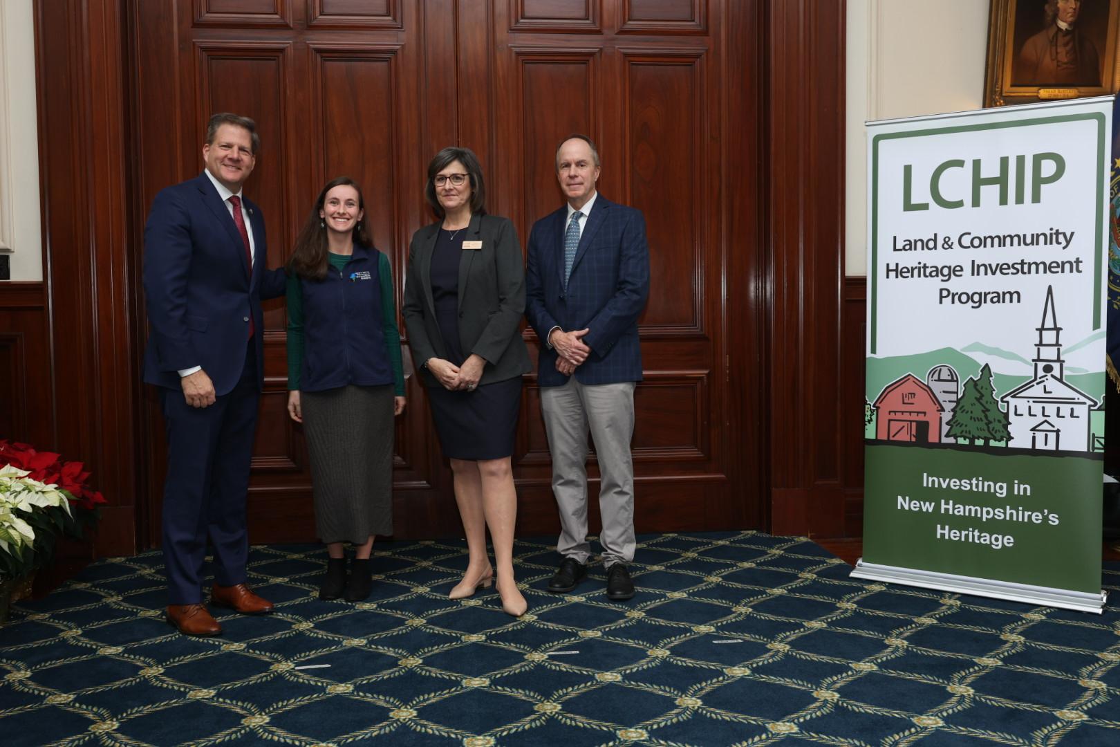 Gov. Sununu poses with Stacie Hernandez and LCHIP leaders at the Statehouse.