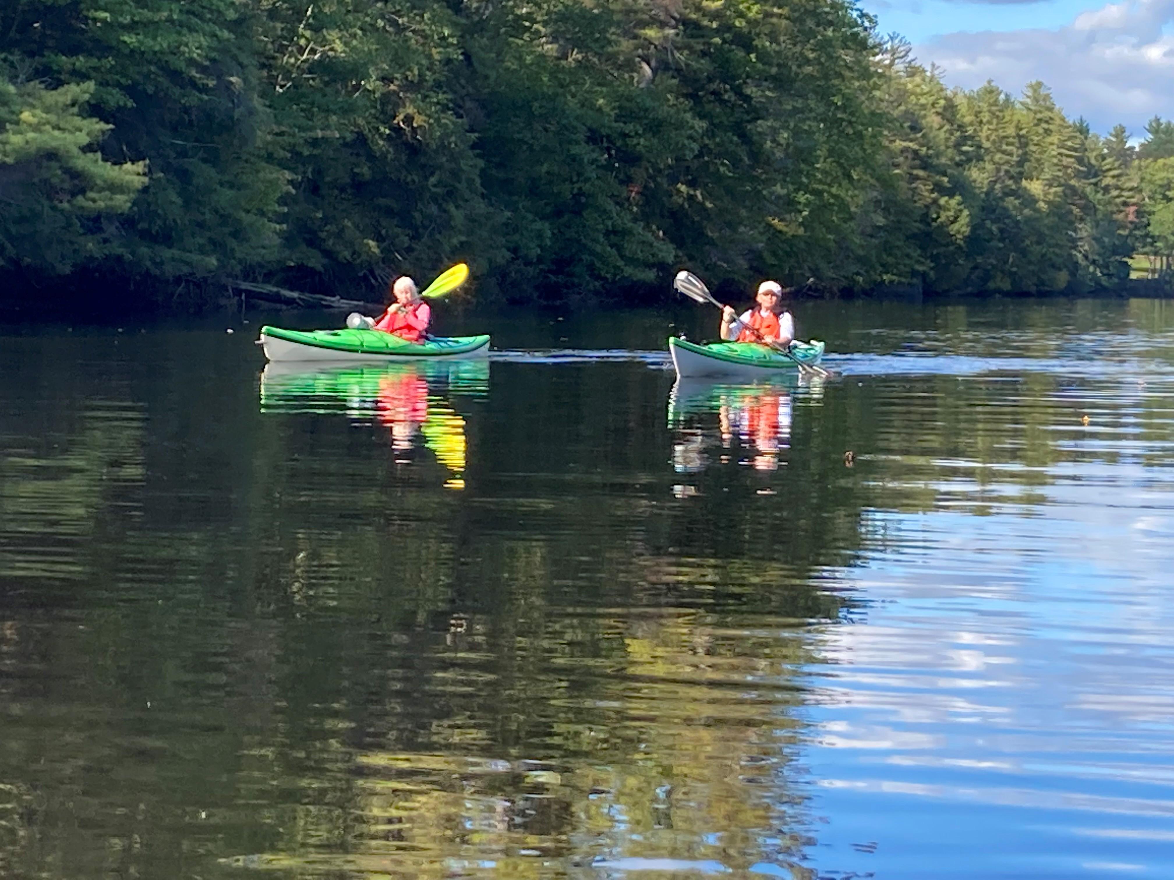 Kayakers paddle on the Contoocook River.