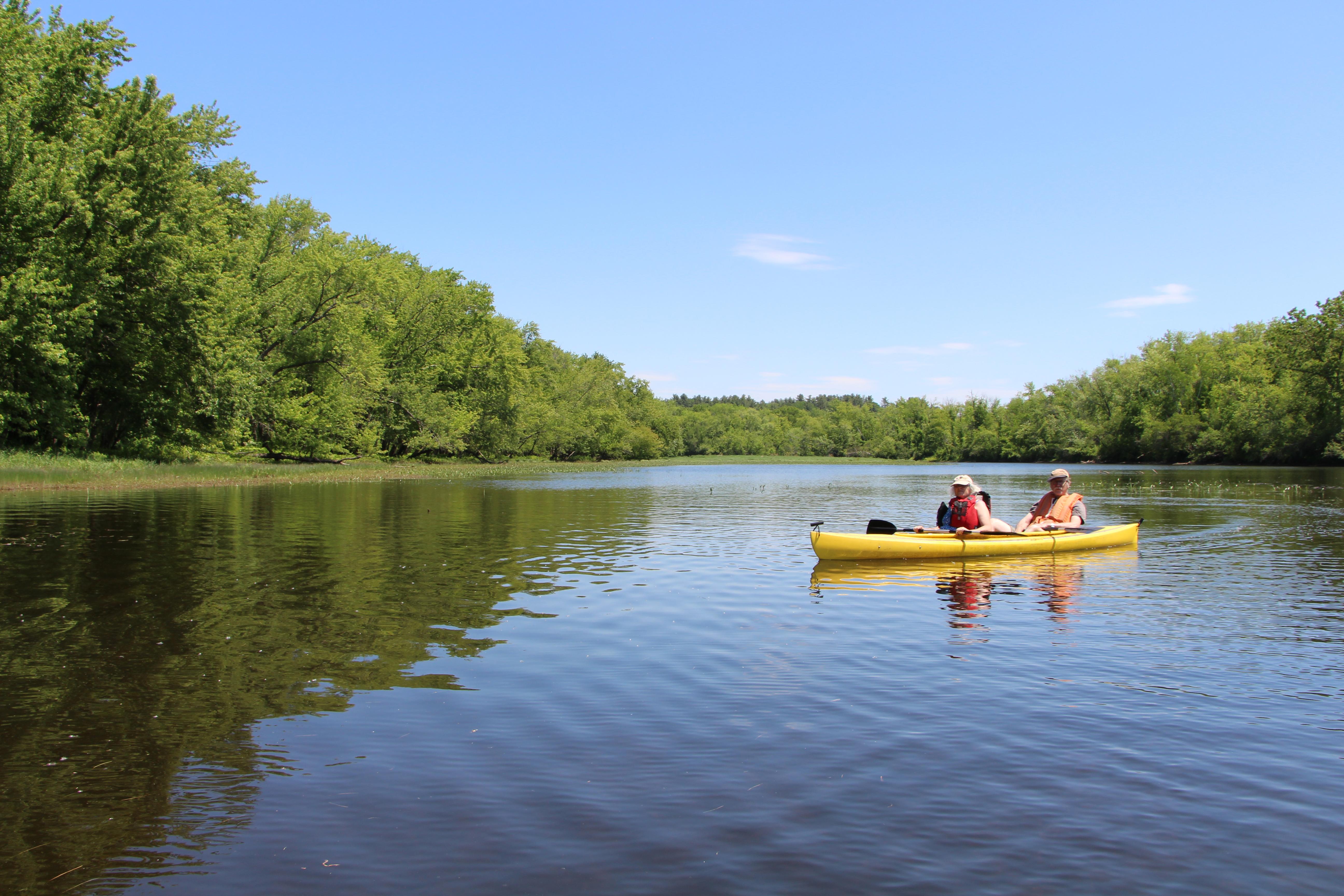A couple in a kayak on the river.