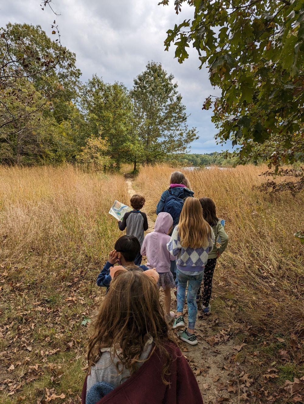 autumn with students walking away from camera