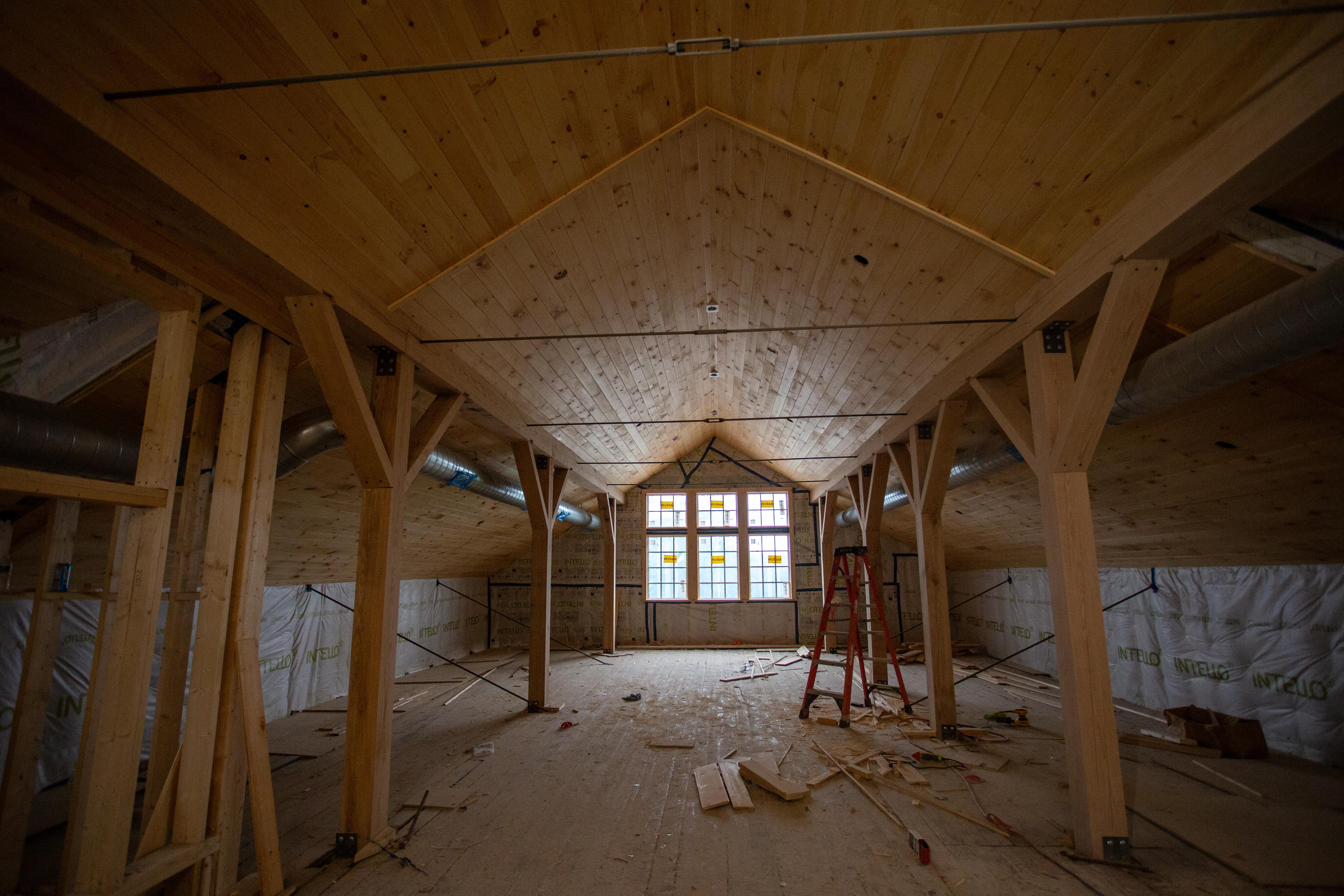 Looking at the wood beams inside the top floor of the Carriage Barn.
