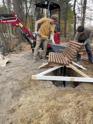 Martin Forestry Consulting and Volunteer set a new bench on accessible trail.