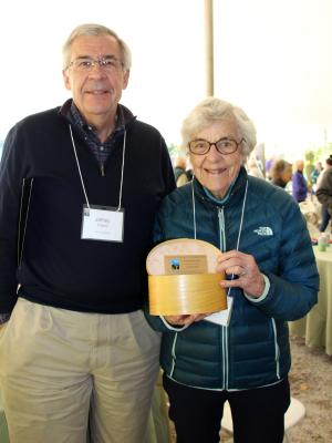 Shirley poses with her son and the box she received at the meeting.