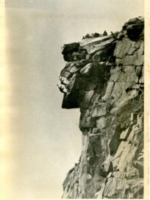 A black and white photo of climbers atop the Old Man.