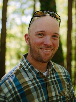 Ryan Smith poses in front of trees near the Conservation Center.