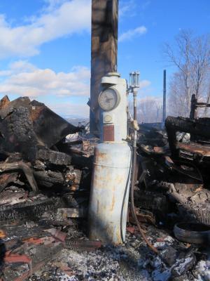 The gas pump, which was once used to fuel farm vehicles at The Rocks and in recent years to add a decorative touch, is left amid the rubble of the Tool Building.