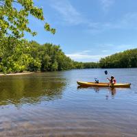 Father and son paddling a kayak on the Merrimack.