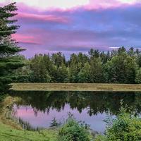 Pink sky at sunset at FarAway Pond in Dalton New Hampshire