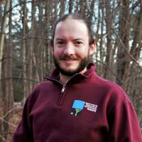 Dylan Summers poses outside on the Conservation Center deck in winter.