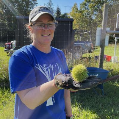 Carrie Deegan holds the first green, spiky, chestnut in fall 2023.