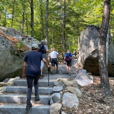 Hikers walk up the new granite steps on the Main Trail.
