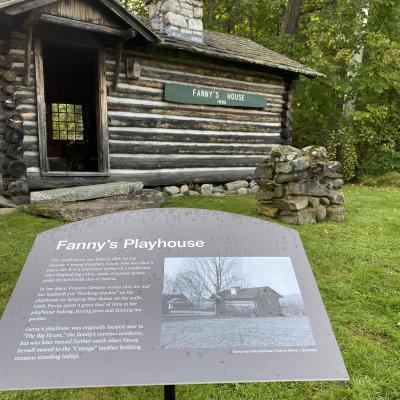 Fanny's playhouse with information in front of it.