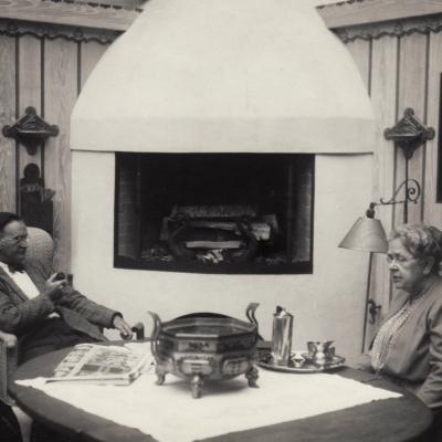 Frances Glessner Lee meets with someone on the porch.