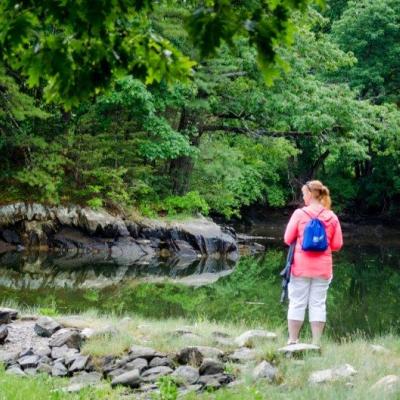 A woman standing on the edge of Sagamore Creek