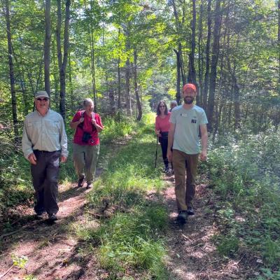 Visitors to the Ammonoosuc River Forest walk to the river.