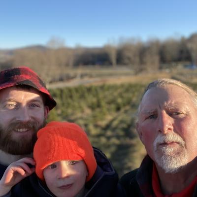 Three smiling wagon riders at The Rocks during Christmas