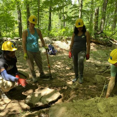 Volunteers point to an area needing improvement on Gap Mountain.