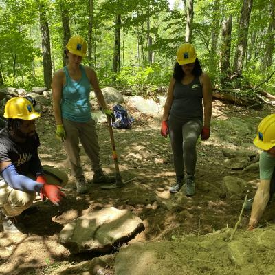 Volunteers point to an area needing improvement on Gap Mountain.