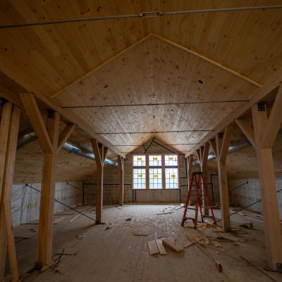Looking at the wood beams inside the top floor of the Carriage Barn.