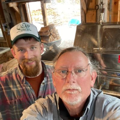Dave Anderson takes a selfie with his son in the sugarhouse at his farm.