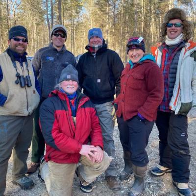 Staff pose for group photo after timber harvest tour