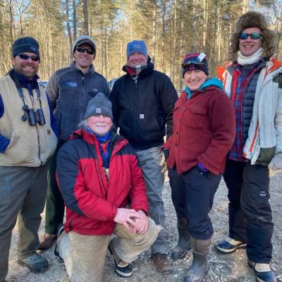 Staff pose for group photo after timber harvest tour