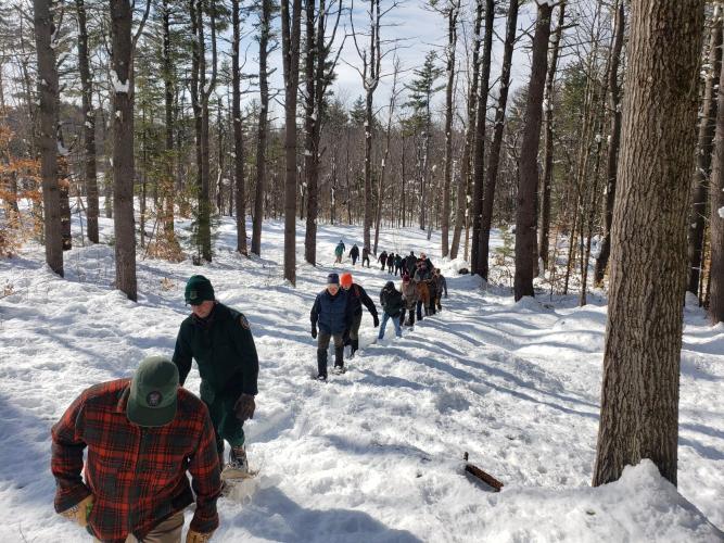 Participants at the SAF regional conference walk at Heald Tract on a snowy path in Wilton.