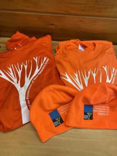 Orange hat and sweatshirt with the Forest Society tree.