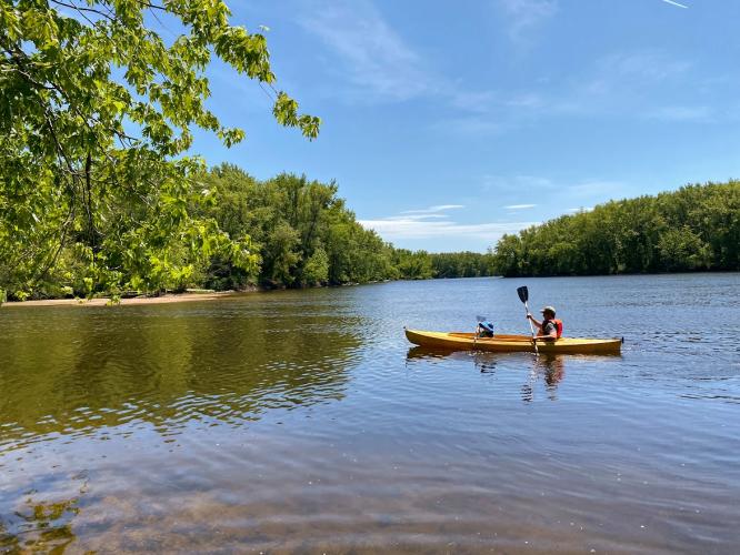 Father and son paddling a kayak on the Merrimack.