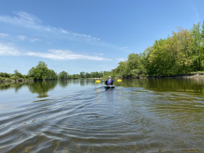 A kayaker paddles on the Merrimack River.