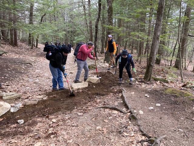 Volunteers dig on the Main Trail at Mount Major as Andy Crowley supervises.