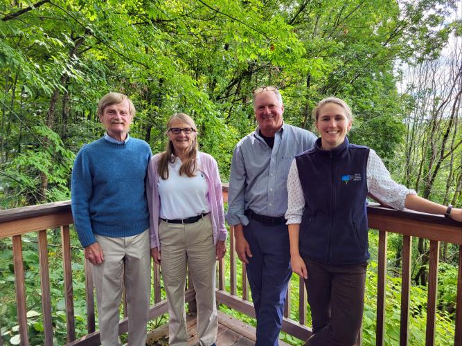 The Murray Family poses with President Jack Savage and Land Conservation Project Manager Leah Hart outside at the Conservation Center.