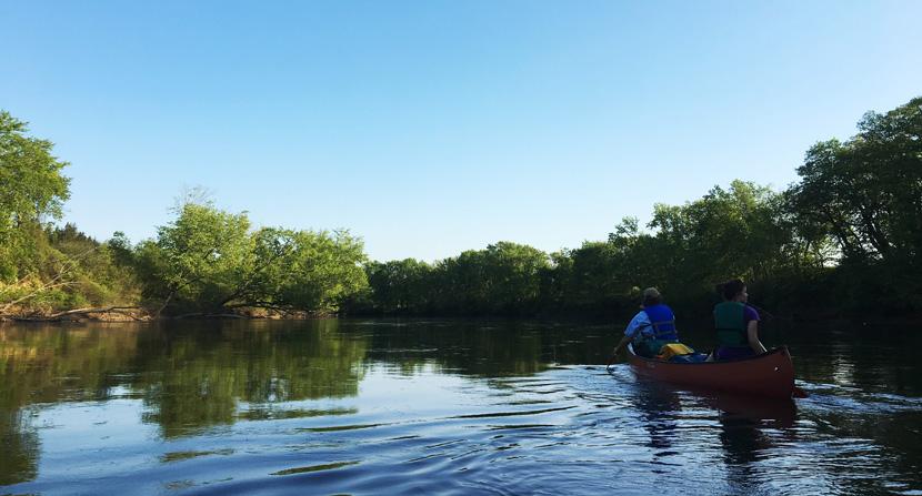 Paddling an Old Town Canoe on the Merrimack River in Summer
