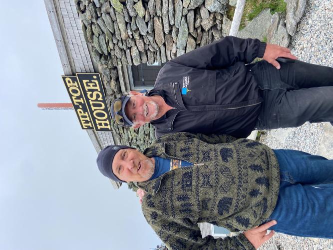 Chris Martin and Dave Anderson pose at the Tip Top House on the summit.